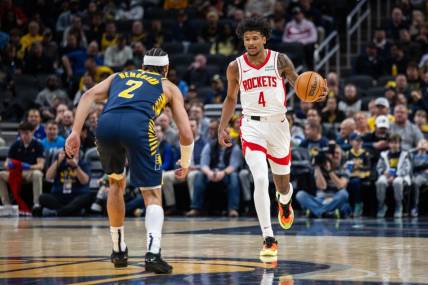 Feb 6, 2024; Indianapolis, Indiana, USA;  Houston Rockets guard Jalen Green (4) dribbles the ball while Indiana Pacers guard Andrew Nembhard (2) defends in the first half at Gainbridge Fieldhouse. Mandatory Credit: Trevor Ruszkowski-USA TODAY Sports