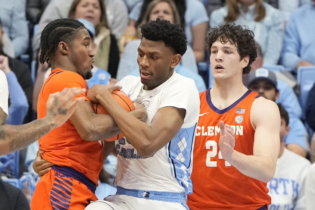 Feb 6, 2024; Chapel Hill, North Carolina, USA; North Carolina Tar Heels forward Jalen Washington (13) and Clemson Tigers forward Chauncey Wiggins (21) and Clemson Tigers center PJ Hall (24) fight for the ball in the first half at Dean E. Smith Center. Mandatory Credit: Bob Donnan-USA TODAY Sports