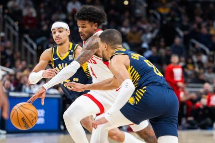 Feb 6, 2024; Indianapolis, Indiana, USA;  Houston Rockets forward Amen Thompson (1) dribbles the ball while Indiana Pacers guard Tyrese Haliburton (0) defends in the first half at Gainbridge Fieldhouse. Mandatory Credit: Trevor Ruszkowski-USA TODAY Sports