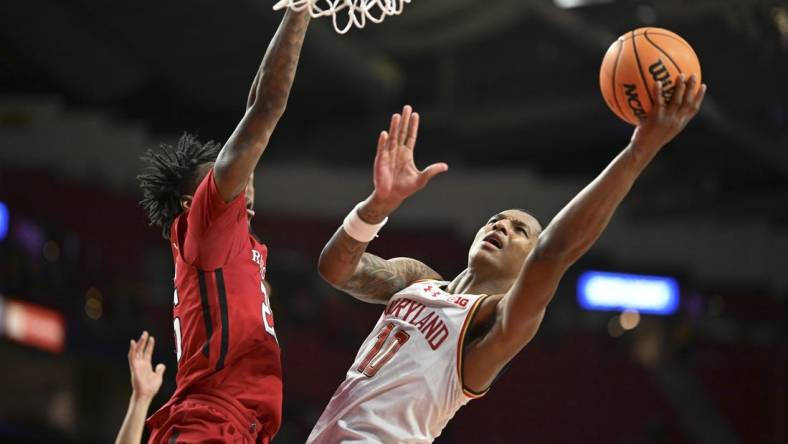 Feb 6, 2024; College Park, Maryland, USA; Maryland Terrapins forward Julian Reese (10) shoots as Rutgers Scarlet Knights center Emmanuel Ogbole (22) defends the basket during the second half  at Xfinity Center. Mandatory Credit: Tommy Gilligan-USA TODAY Sports