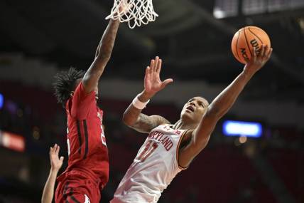 Feb 6, 2024; College Park, Maryland, USA; Maryland Terrapins forward Julian Reese (10) shoots as Rutgers Scarlet Knights center Emmanuel Ogbole (22) defends the basket during the second half  at Xfinity Center. Mandatory Credit: Tommy Gilligan-USA TODAY Sports