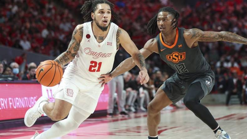 Feb 6, 2024; Houston, Texas, USA; Houston Cougars guard Emanuel Sharp (21) drives with the ball as Oklahoma State Cowboys guard Javon Small (12) defends during the second half at Fertitta Center. Mandatory Credit: Troy Taormina-USA TODAY Sports