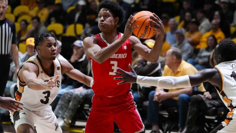 Feb 6, 2024; Laramie, Wyoming, USA; New Mexico Lobos guard Tru Washington (3) looks to pass against Wyoming Cowboys guard Sam Griffin (3) during the first half at Arena-Auditorium. Mandatory Credit: Troy Babbitt-USA TODAY Sports