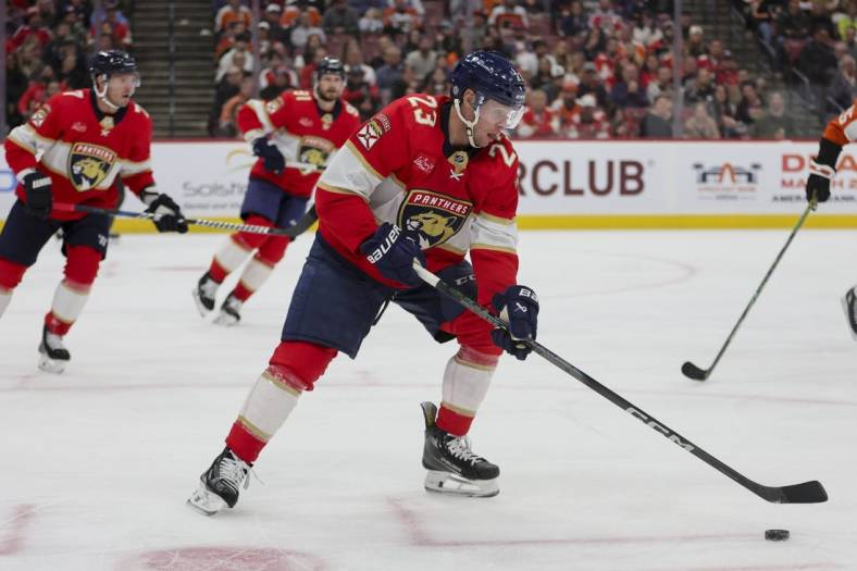 Feb 6, 2024; Sunrise, Florida, USA; Florida Panthers center Carter Verhaeghe (23) moves the puck against the Philadelphia Flyers during the third period at Amerant Bank Arena. Mandatory Credit: Sam Navarro-USA TODAY Sports