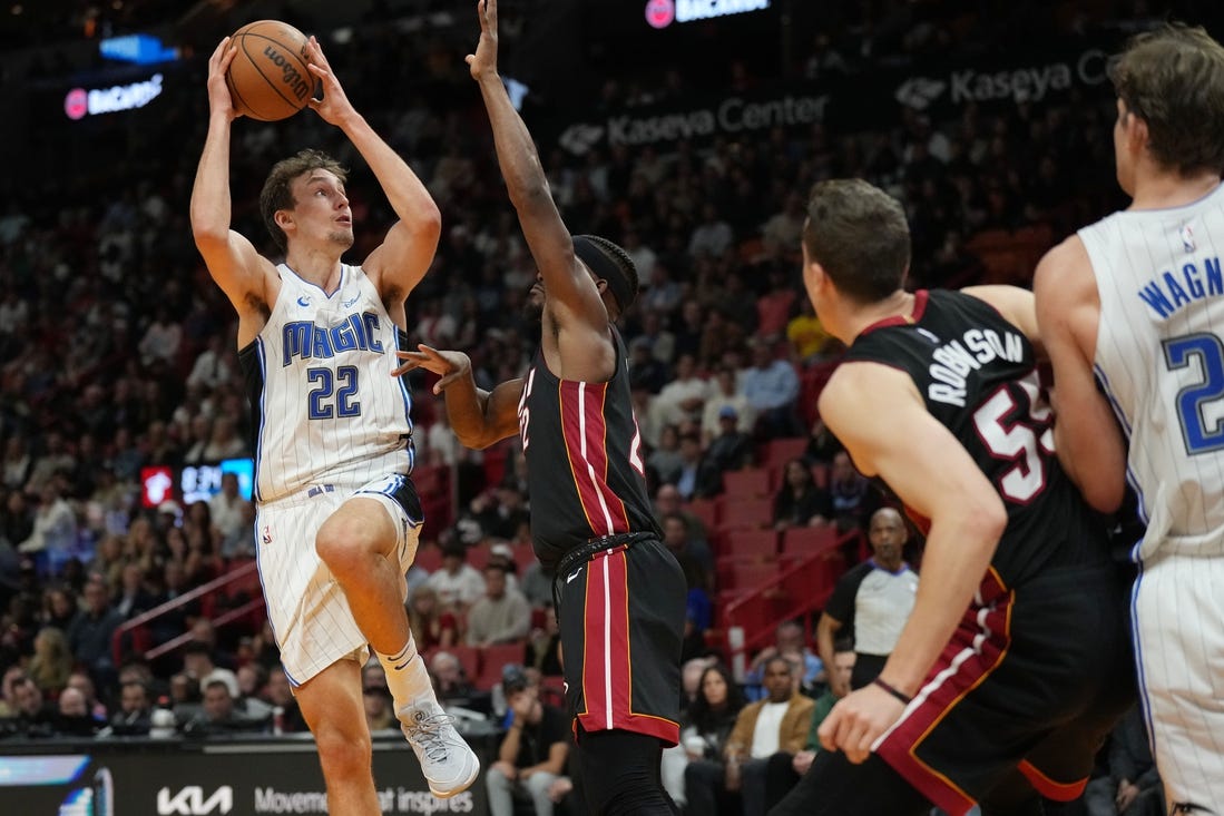 Feb 6, 2024; Miami, Florida, USA;  Orlando Magic forward Franz Wagner (22) goes up for a shot over Miami Heat forward Jimmy Butler (22) during the second half at Kaseya Center. Mandatory Credit: Jim Rassol-USA TODAY Sports