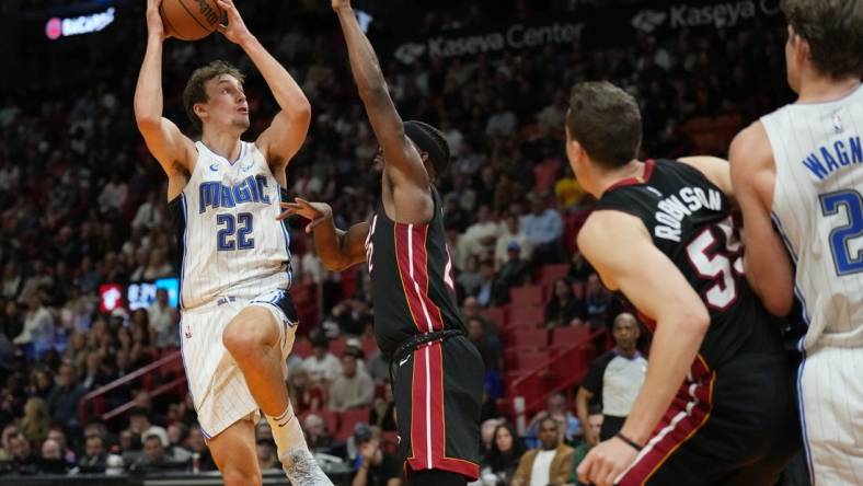 Feb 6, 2024; Miami, Florida, USA;  Orlando Magic forward Franz Wagner (22) goes up for a shot over Miami Heat forward Jimmy Butler (22) during the second half at Kaseya Center. Mandatory Credit: Jim Rassol-USA TODAY Sports