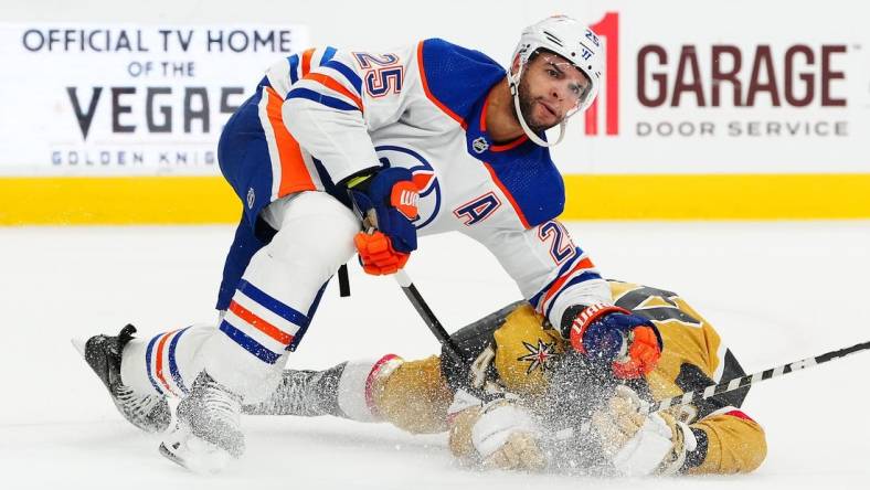 Feb 6, 2024; Las Vegas, Nevada, USA; Edmonton Oilers defenseman Darnell Nurse (25) takes down Vegas Golden Knights center Paul Cotter (43) during the first period at T-Mobile Arena. Mandatory Credit: Stephen R. Sylvanie-USA TODAY Sports