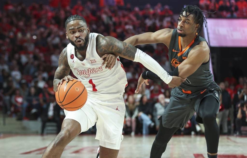 Feb 6, 2024; Houston, Texas, USA; Houston Cougars guard Jamal Shead (1) drives with the ball as Oklahoma State Cowboys guard Jarius Hicklen (4) defends during the second half at Fertitta Center. Mandatory Credit: Troy Taormina-USA TODAY Sports