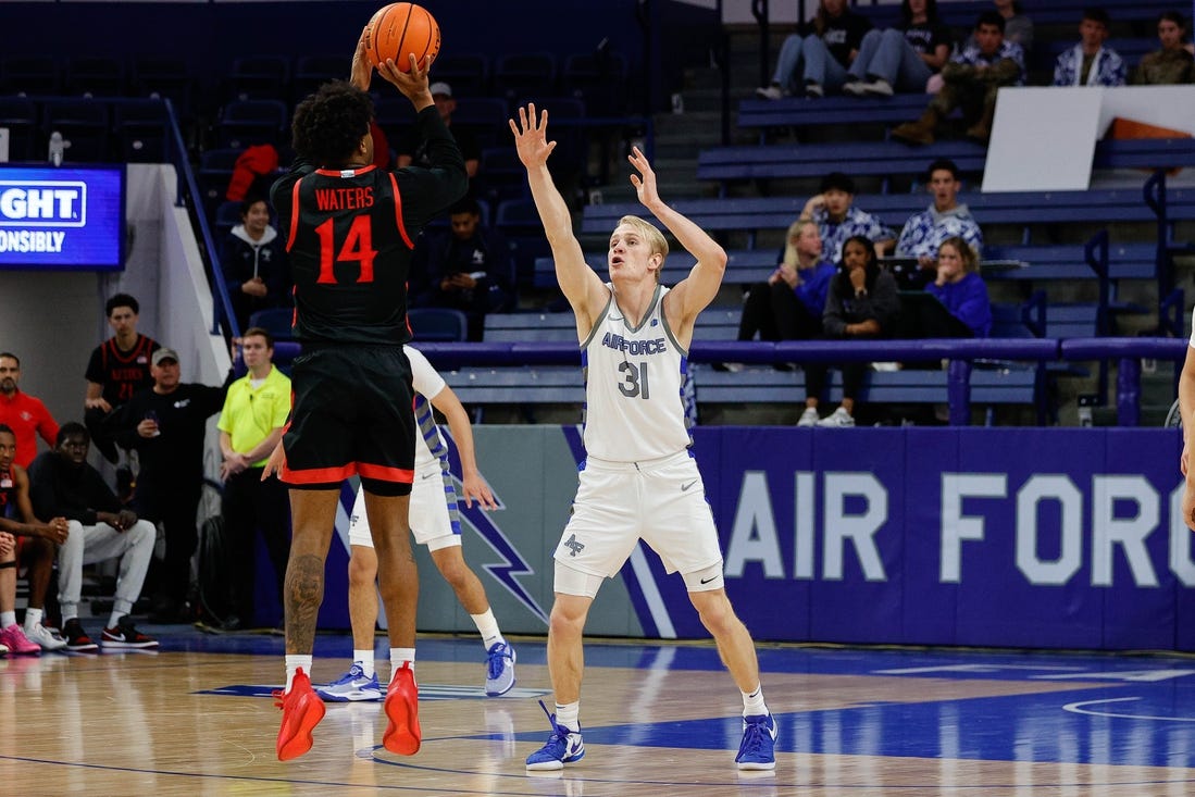 Feb 6, 2024; Colorado Springs, Colorado, USA; San Diego State Aztecs guard Reese Waters (14) attempts a shot as Air Force Falcons forward Rytis Petraitis (31) defends in the second half at Clune Arena. Mandatory Credit: Isaiah J. Downing-USA TODAY Sports