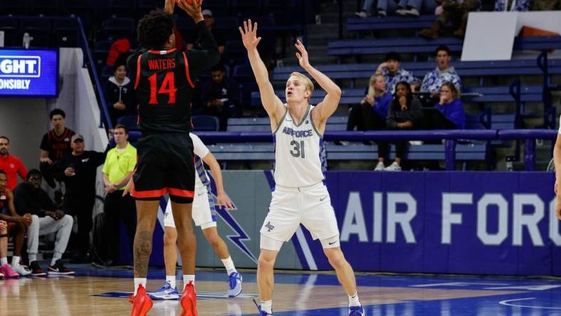 Feb 6, 2024; Colorado Springs, Colorado, USA; San Diego State Aztecs guard Reese Waters (14) attempts a shot as Air Force Falcons forward Rytis Petraitis (31) defends in the second half at Clune Arena. Mandatory Credit: Isaiah J. Downing-USA TODAY Sports