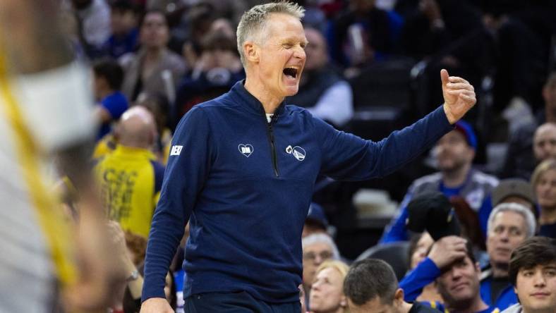 Feb 7, 2024; Philadelphia, Pennsylvania, USA; Golden State Warriors head coach Steve Kerr reacts after a score against the Philadelphia 76ers during the third quarter at Wells Fargo Center. Mandatory Credit: Bill Streicher-USA TODAY Sports