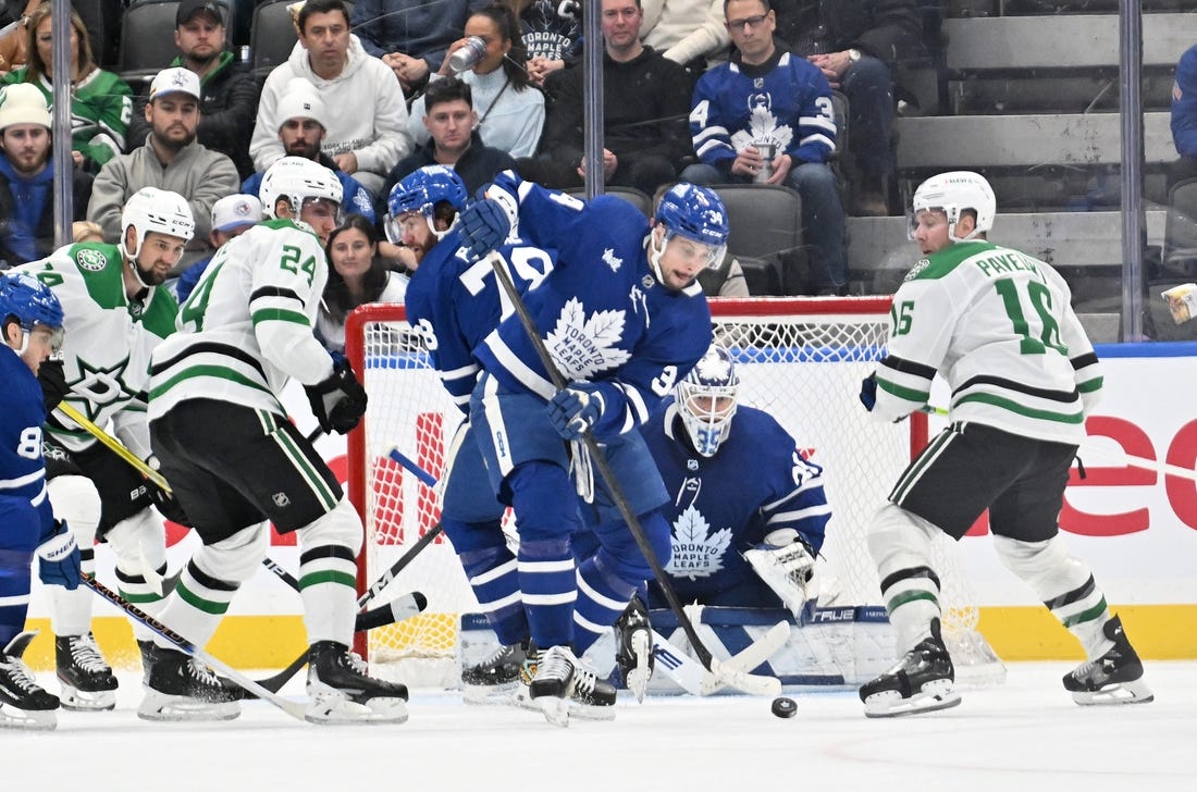 Feb 7, 2024; Toronto, Ontario, CAN; Toronto Maple Leafs forward Auston Matthews (34) clears the puck away from goalie Ilya Samsonov (35) as Dallas Stars forwards Joe Pavelski (16) and Roope Hintz (24) look on in the third period at Scotiabank Arena. Mandatory Credit: Dan Hamilton-USA TODAY Sports