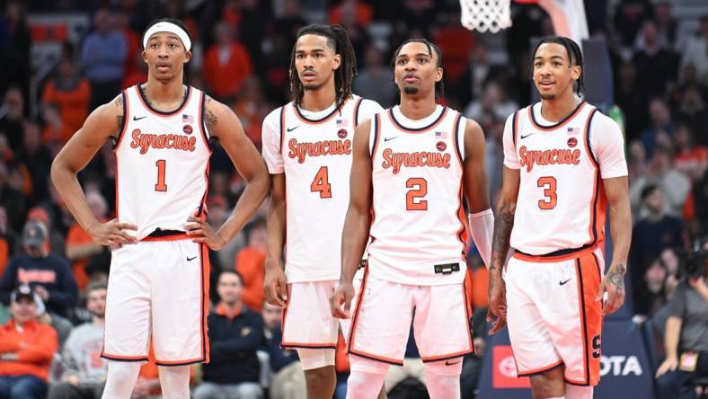 Feb 7, 2024; Syracuse, New York, USA; Syracuse Orange forward Maliq Brown (1) and forward Chris Bell (4) and guard JJ Starling (2) and guard Judah Mintz (3) watch a free throw down court in the second half against the Louisville Cardinals at the JMA Wireless Dome. Mandatory Credit: Mark Konezny-USA TODAY Sports