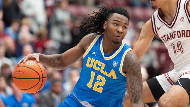 Feb 7, 2024; Stanford, California, USA;  UCLA Bruins guard Sebastian Mack (12) controls the ball during the second half against Stanford Cardinal forward Spencer Jones (14) at Maples Pavilion. Mandatory Credit: Stan Szeto-USA TODAY Sports