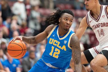 Feb 7, 2024; Stanford, California, USA;  UCLA Bruins guard Sebastian Mack (12) controls the ball during the second half against Stanford Cardinal forward Spencer Jones (14) at Maples Pavilion. Mandatory Credit: Stan Szeto-USA TODAY Sports