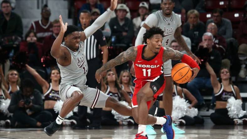 Feb 7, 2024; Starkville, Mississippi, USA; Georgia Bulldogs guard Justin Hill (11) dribbles as Mississippi State Bulldogs guard Josh Hubbard (13) defends during the second half at Humphrey Coliseum. Mandatory Credit: Petre Thomas-USA TODAY Sports