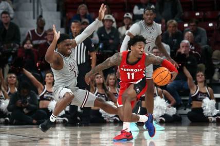 Feb 7, 2024; Starkville, Mississippi, USA; Georgia Bulldogs guard Justin Hill (11) dribbles as Mississippi State Bulldogs guard Josh Hubbard (13) defends during the second half at Humphrey Coliseum. Mandatory Credit: Petre Thomas-USA TODAY Sports