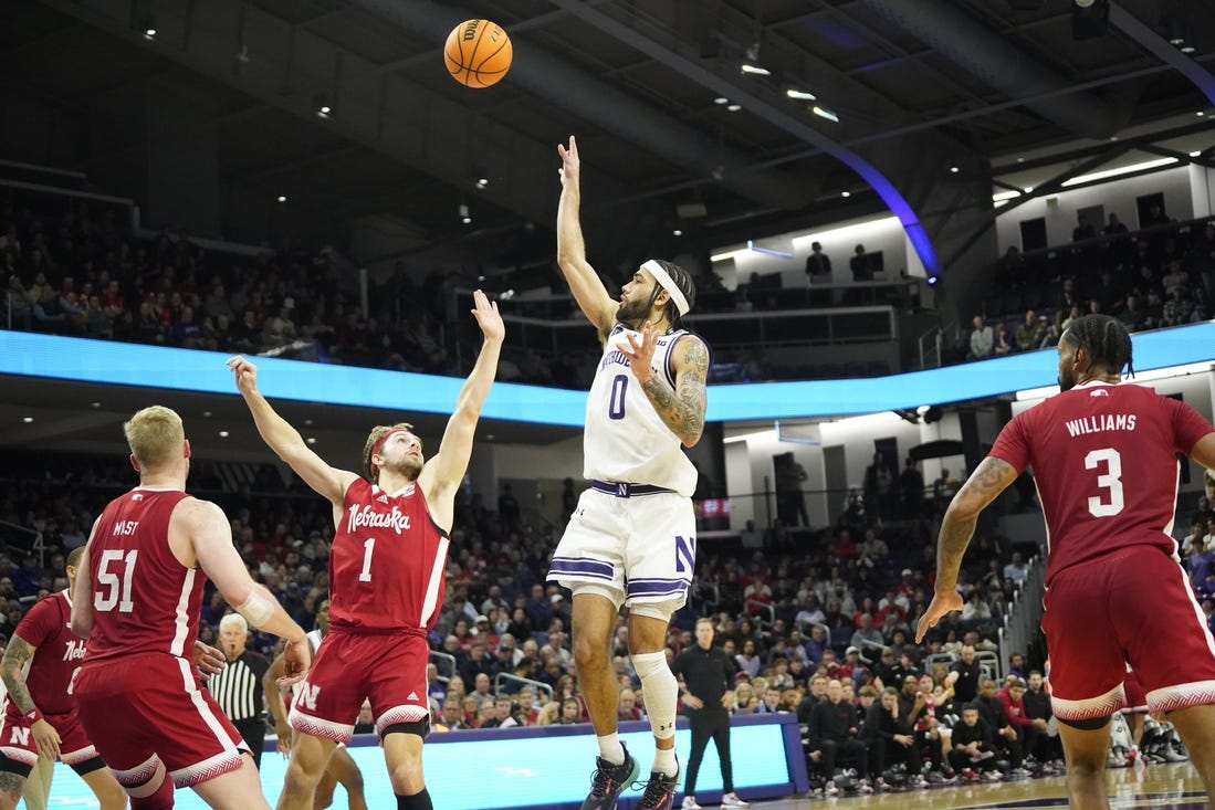 Feb 7, 2024; Evanston, Illinois, USA; Northwestern Wildcats guard Boo Buie (0) shoots over Nebraska Cornhuskers guard Sam Hoiberg (1) during the second half at Welsh-Ryan Arena. Mandatory Credit: David Banks-USA TODAY Sports