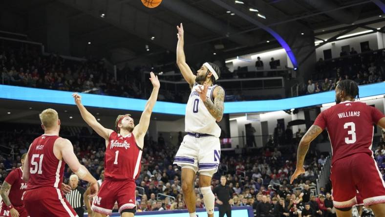 Feb 7, 2024; Evanston, Illinois, USA; Northwestern Wildcats guard Boo Buie (0) shoots over Nebraska Cornhuskers guard Sam Hoiberg (1) during the second half at Welsh-Ryan Arena. Mandatory Credit: David Banks-USA TODAY Sports