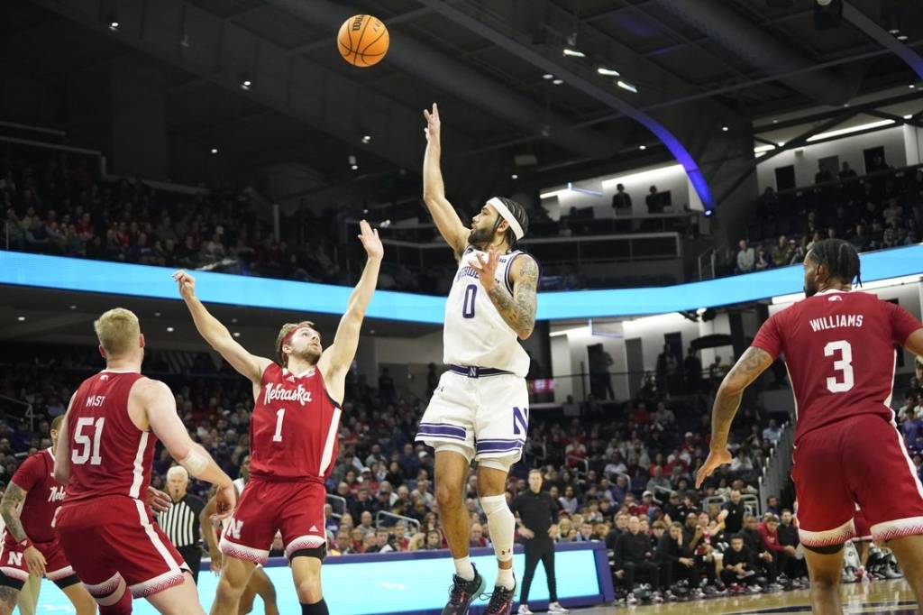 Feb 7, 2024; Evanston, Illinois, USA; Northwestern Wildcats guard Boo Buie (0) shoots over Nebraska Cornhuskers guard Sam Hoiberg (1) during the second half at Welsh-Ryan Arena. Mandatory Credit: David Banks-USA TODAY Sports