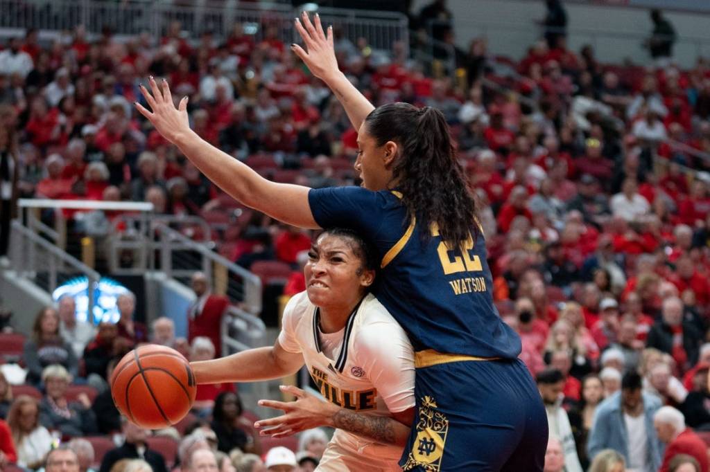 Louisville Cardinals forward Nyla Harris (2) attempts to get around Notre Dame Fighting Irish forward Kylee Watson (22) for a layup during their game on Thursday, Feb. 8, 2024 at KFC YUM Center.