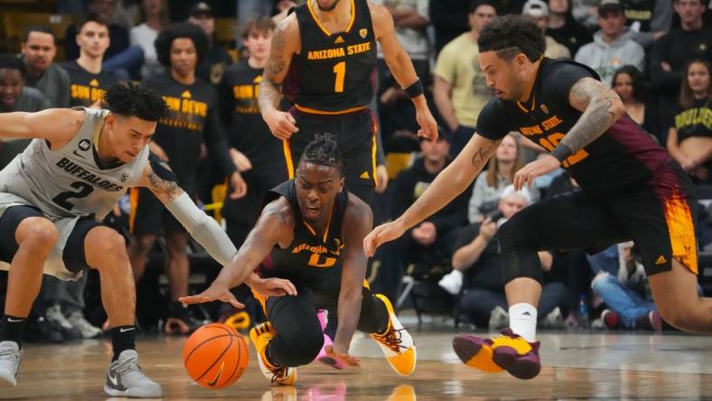 Feb 8, 2024; Boulder, Colorado, USA; Arizona State Sun Devils guard Kamari Lands (0) and guard Jose Perez (12) and Colorado Buffaloes guard KJ Simpson (2) reach for a loose ball in the first half at the CU Events Center. Mandatory Credit: Ron Chenoy-USA TODAY Sports