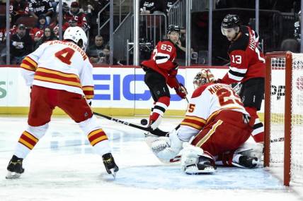 Feb 8, 2024; Newark, New Jersey, USA; Calgary Flames goaltender Jacob Markstrom (25) makes a save against the New Jersey Devils during the second period at Prudential Center. Mandatory Credit: John Jones-USA TODAY Sports