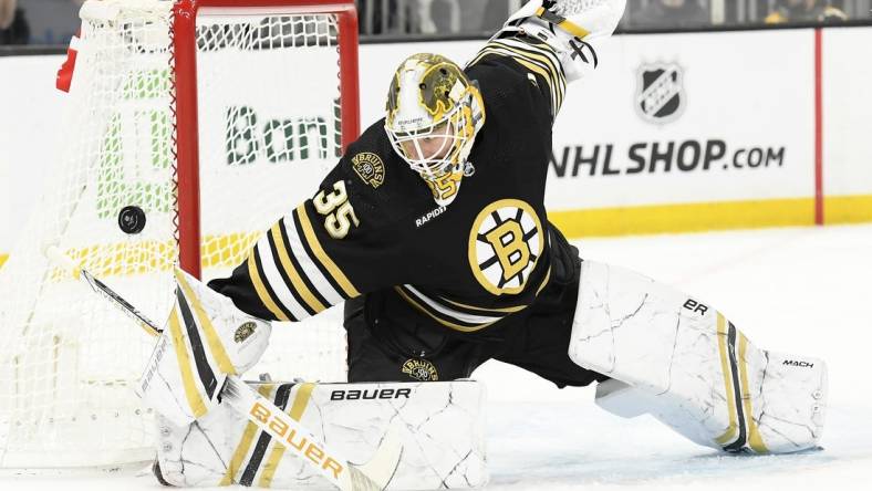 Feb 8, 2024; Boston, Massachusetts, USA; Boston Bruins goaltender Linus Ullmark (35) makes a save during the second period against the Vancouver Canucks at TD Garden. Mandatory Credit: Bob DeChiara-USA TODAY Sports