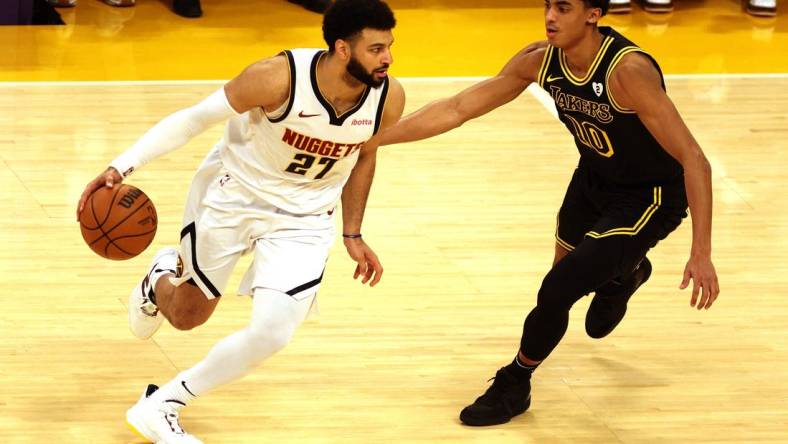 Feb 8, 2024; Los Angeles, California, USA; Denver Nuggets guard Jamal Murray (27) dribbles against Los Angeles Lakers guard Max Christie (10) during the first quarter at Crypto.com Arena. Mandatory Credit: Jason Parkhurst-USA TODAY Sports