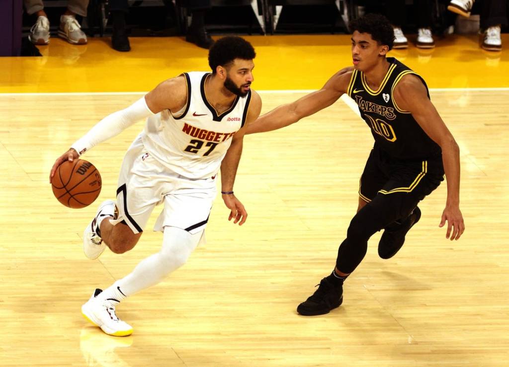 Feb 8, 2024; Los Angeles, California, USA; Denver Nuggets guard Jamal Murray (27) dribbles against Los Angeles Lakers guard Max Christie (10) during the first quarter at Crypto.com Arena. Mandatory Credit: Jason Parkhurst-USA TODAY Sports