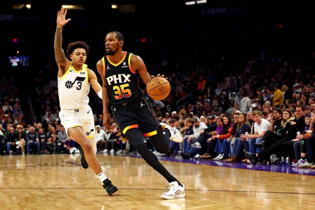 Feb 8, 2024; Phoenix, Arizona, USA; Phoenix Suns forward Kevin Durant (35) drives to the basket against Utah Jazz guard Keyonte George (3) during the third quarter at Footprint Center. Mandatory Credit: Mark J. Rebilas-USA TODAY Sports