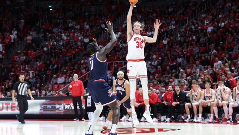 Feb 8, 2024; Salt Lake City, Utah, USA; Utah Utes center Branden Carlson (35) shoots over Arizona Wildcats center Oumar Ballo (11) during second overtime at Jon M. Huntsman Center. Mandatory Credit: Rob Gray-USA TODAY Sports