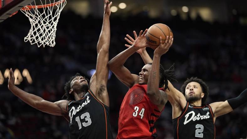 Feb 8, 2024; Portland, Oregon, USA; Portland Trail Blazers forward Jabari Walker (34) shoots the ball against Detroit Pistons center James Wiseman (13) and point guard Cade Cunningham (2) during the second half at Moda Center. Mandatory Credit: Soobum Im-USA TODAY Sports