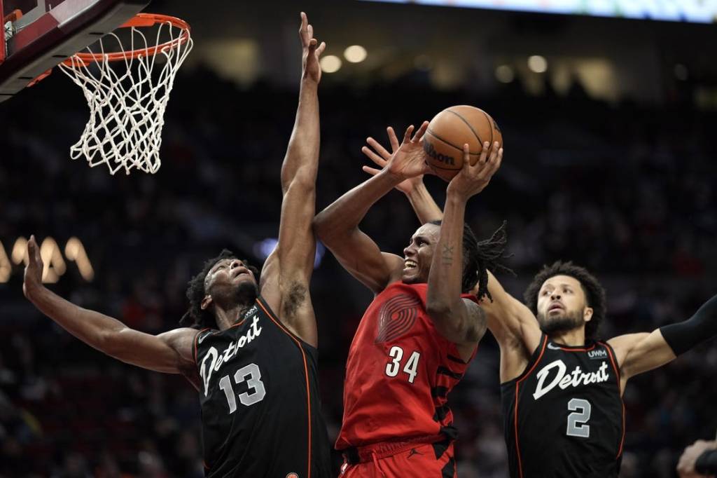 Feb 8, 2024; Portland, Oregon, USA; Portland Trail Blazers forward Jabari Walker (34) shoots the ball against Detroit Pistons center James Wiseman (13) and point guard Cade Cunningham (2) during the second half at Moda Center. Mandatory Credit: Soobum Im-USA TODAY Sports