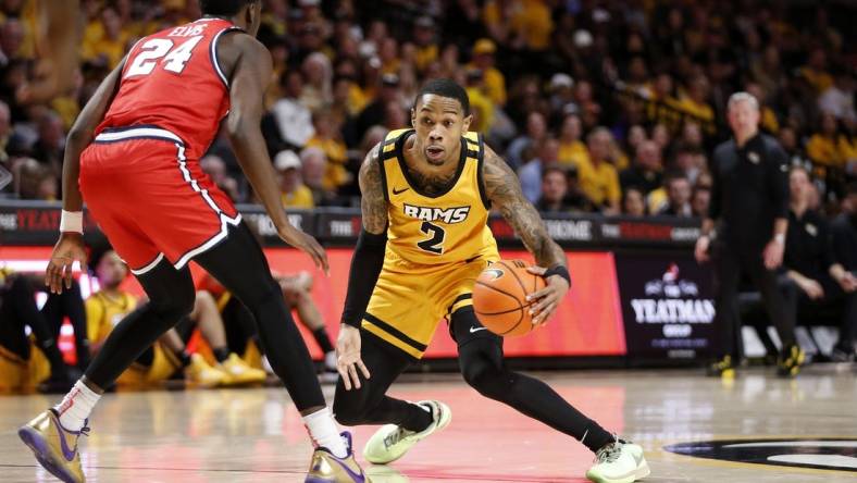 Feb 9, 2024; Richmond, Virginia, USA; Virginia Commonwealth Rams guard Zeb Jackson (2) dribbles the ball as Dayton Flyers guard Kobe Elvis (24) defends during the first half at Stuart C. Siegel Center. Mandatory Credit: Amber Searls-USA TODAY Sports