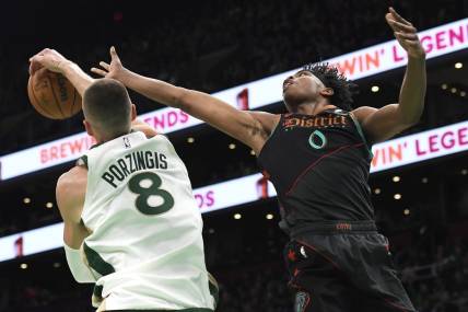 Feb 9, 2024; Boston, Massachusetts, USA; Boston Celtics center Kristaps Porzingis (8) blocks the shot of Washington Wizards guard Bilal Coulibaly (0) during the first half at TD Garden. Mandatory Credit: Bob DeChiara-USA TODAY Sports