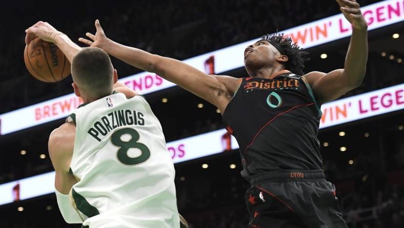 Feb 9, 2024; Boston, Massachusetts, USA; Boston Celtics center Kristaps Porzingis (8) blocks the shot of Washington Wizards guard Bilal Coulibaly (0) during the first half at TD Garden. Mandatory Credit: Bob DeChiara-USA TODAY Sports