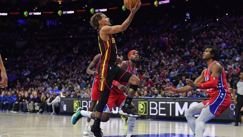 Feb 9, 2024; Philadelphia, Pennsylvania, USA; Atlanta Hawks guard Trae Young (11) drives to the basket past Philadelphia 76ers guard Buddy Hield (17) during the second quarter at Wells Fargo Center. Mandatory Credit: Eric Hartline-USA TODAY Sports