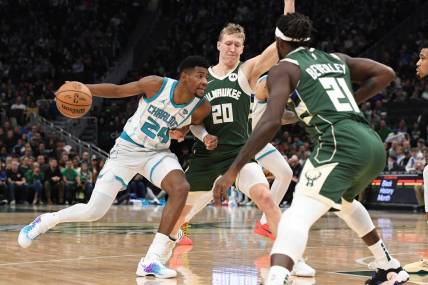 Feb 9, 2024; Milwaukee, Wisconsin, USA; Charlotte Hornets forward Brandon Miller (24) drives against  Milwaukee Bucks guard AJ Green (20) and guard Patrick Beverley (21) in the first half at Fiserv Forum. Mandatory Credit: Michael McLoone-USA TODAY Sports