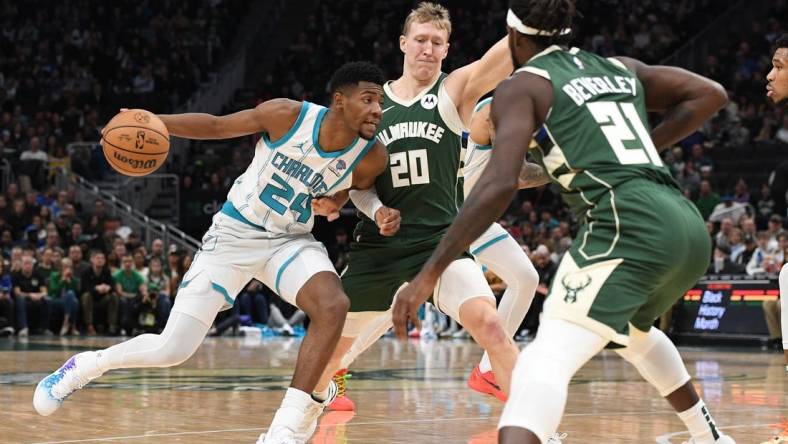 Feb 9, 2024; Milwaukee, Wisconsin, USA; Charlotte Hornets forward Brandon Miller (24) drives against  Milwaukee Bucks guard AJ Green (20) and guard Patrick Beverley (21) in the first half at Fiserv Forum. Mandatory Credit: Michael McLoone-USA TODAY Sports