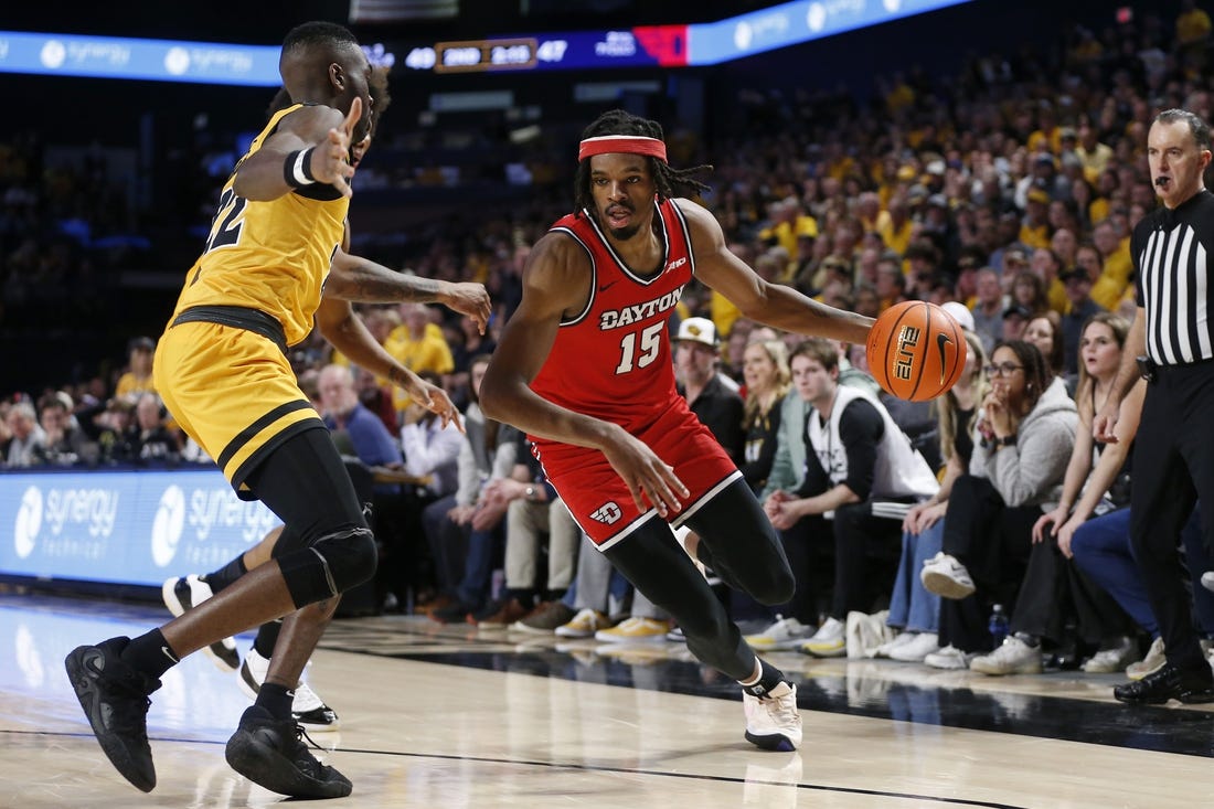 Feb 9, 2024; Richmond, Virginia, USA; Dayton Flyers forward DaRon Holmes II (15) controls the ball as Virginia Commonwealth Rams guard Joe Bamisile (22) defends during the second half at Stuart C. Siegel Center. Mandatory Credit: Amber Searls-USA TODAY Sports