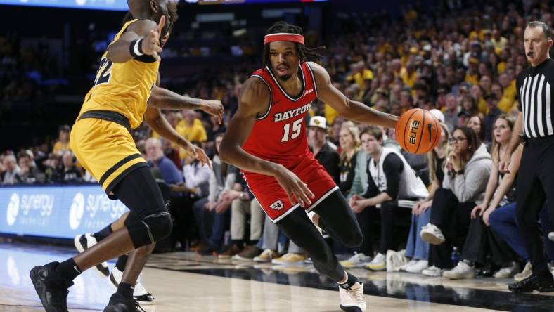 Feb 9, 2024; Richmond, Virginia, USA; Dayton Flyers forward DaRon Holmes II (15) controls the ball as Virginia Commonwealth Rams guard Joe Bamisile (22) defends during the second half at Stuart C. Siegel Center. Mandatory Credit: Amber Searls-USA TODAY Sports