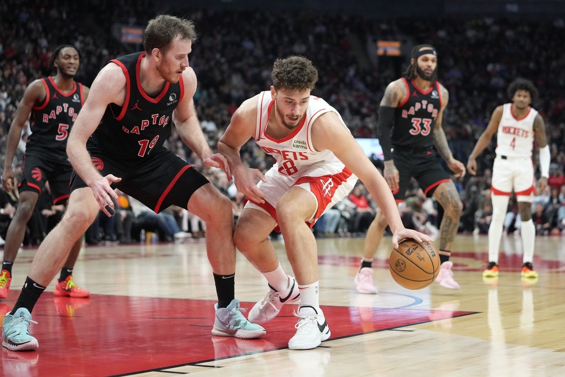 Feb 9, 2024; Toronto, Ontario, CAN; Houston Rockets center Alperen Sengun (28) controls the ball against Toronto Raptors center Jakob Poeltl (19) during the second half at Scotiabank Arena. Mandatory Credit: John E. Sokolowski-USA TODAY Sports