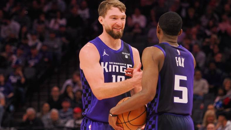 Feb 9, 2024; Sacramento, California, USA; Sacramento Kings center Domantas Sabonis (10) smiles with guard De'Aaron Fox (5) after a play against the Denver Nuggets during the second quarter at Golden 1 Center. Mandatory Credit: Kelley L Cox-USA TODAY Sports