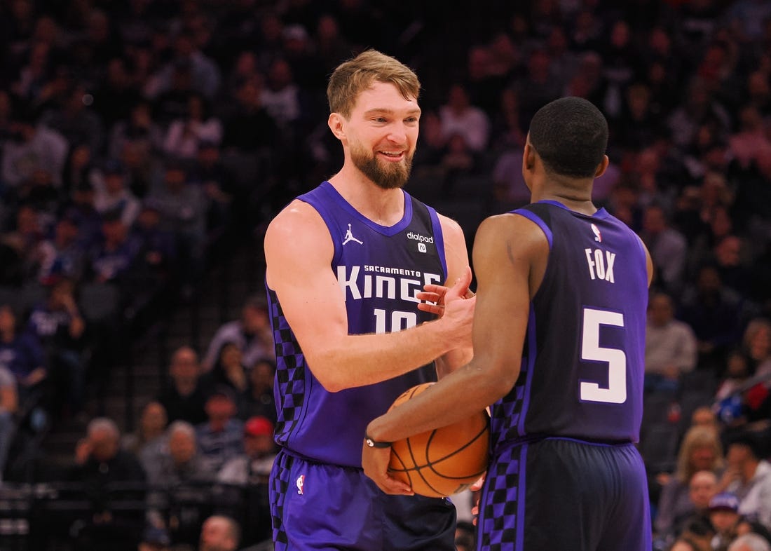 Feb 9, 2024; Sacramento, California, USA; Sacramento Kings center Domantas Sabonis (10) smiles with guard De'Aaron Fox (5) after a play against the Denver Nuggets during the second quarter at Golden 1 Center. Mandatory Credit: Kelley L Cox-USA TODAY Sports