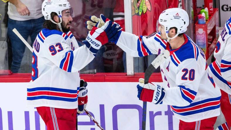 Feb 9, 2024; Chicago, Illinois, USA; New York Rangers center Mika Zibanejad (93) celebrates with center Rem Pitlick (20) against the Chicago Blackhawks after the game at the United Center. Mandatory Credit: Daniel Bartel-USA TODAY Sports