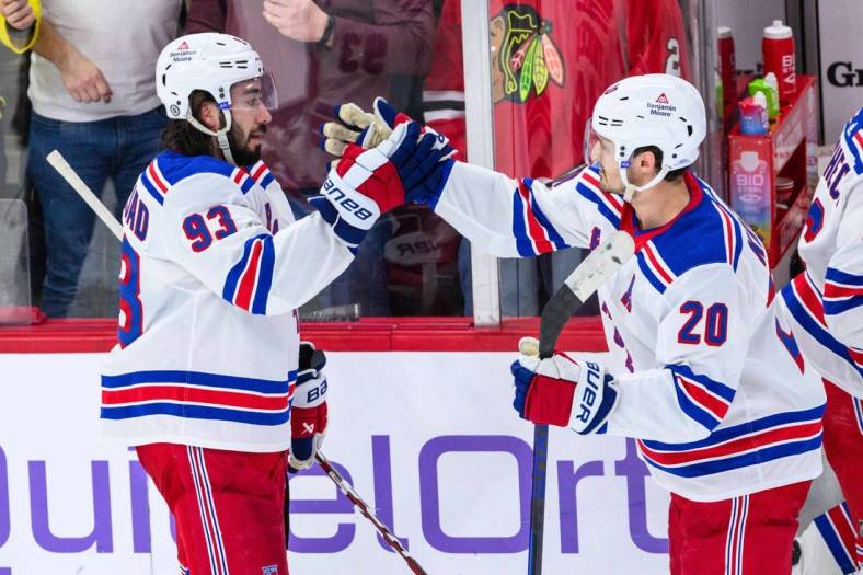 Feb 9, 2024; Chicago, Illinois, USA; New York Rangers center Mika Zibanejad (93) celebrates with center Rem Pitlick (20) against the Chicago Blackhawks after the game at the United Center. Mandatory Credit: Daniel Bartel-USA TODAY Sports