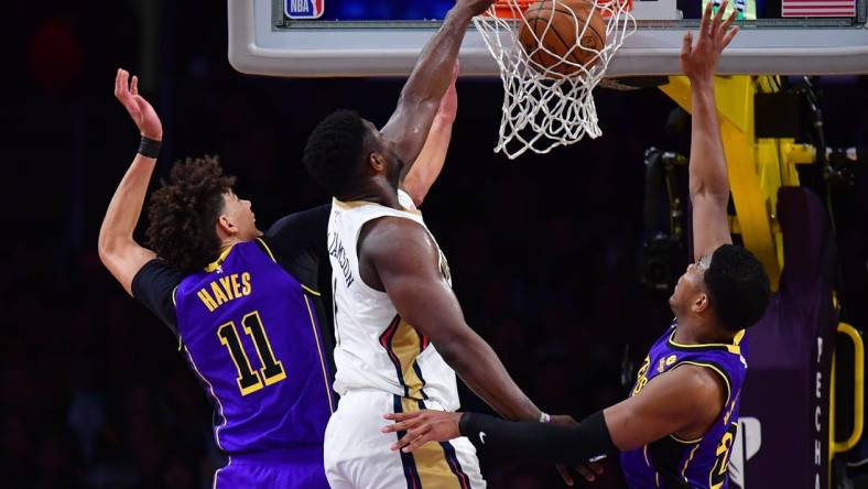 Feb 9, 2024; Los Angeles, California, USA; New Orleans Pelicans forward Zion Williamson (1) dunks for the basket against Los Angeles Lakers forward Rui Hachimura (28) and center Jaxson Hayes (11) during the first half at Crypto.com Arena. Mandatory Credit: Gary A. Vasquez-USA TODAY Sports