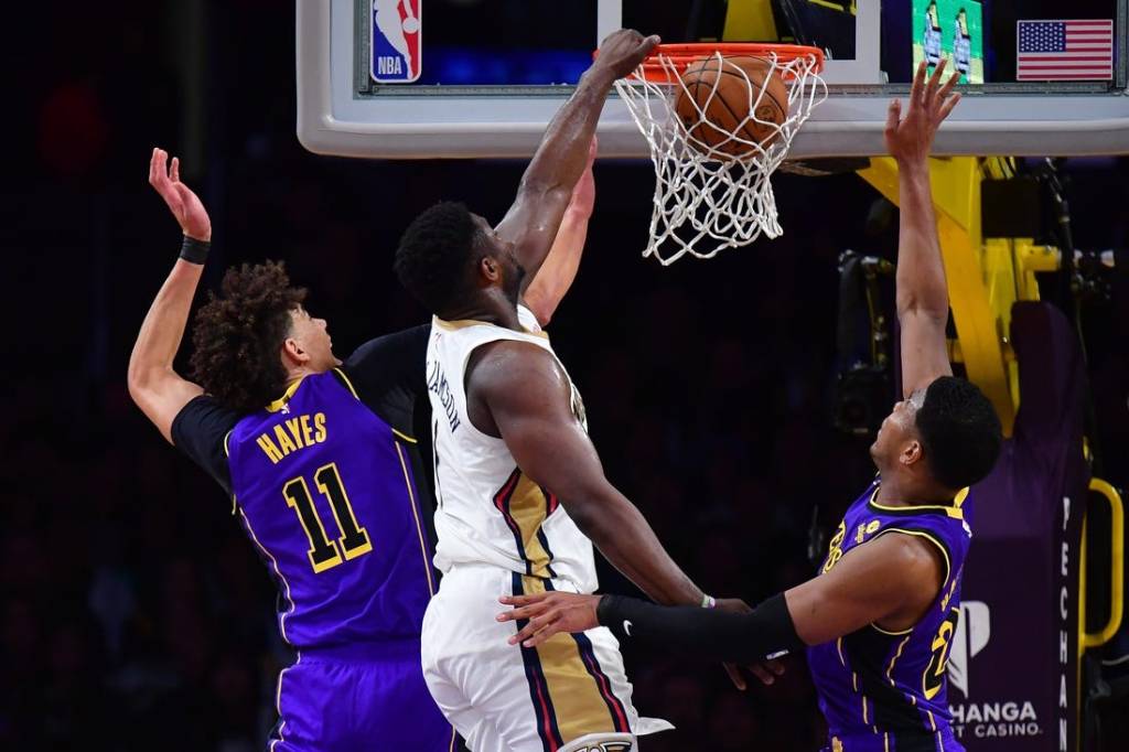 Feb 9, 2024; Los Angeles, California, USA; New Orleans Pelicans forward Zion Williamson (1) dunks for the basket against Los Angeles Lakers forward Rui Hachimura (28) and center Jaxson Hayes (11) during the first half at Crypto.com Arena. Mandatory Credit: Gary A. Vasquez-USA TODAY Sports