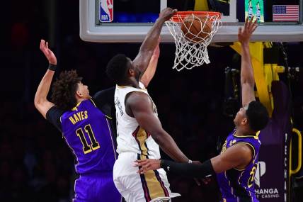 Feb 9, 2024; Los Angeles, California, USA; New Orleans Pelicans forward Zion Williamson (1) dunks for the basket against Los Angeles Lakers forward Rui Hachimura (28) and center Jaxson Hayes (11) during the first half at Crypto.com Arena. Mandatory Credit: Gary A. Vasquez-USA TODAY Sports